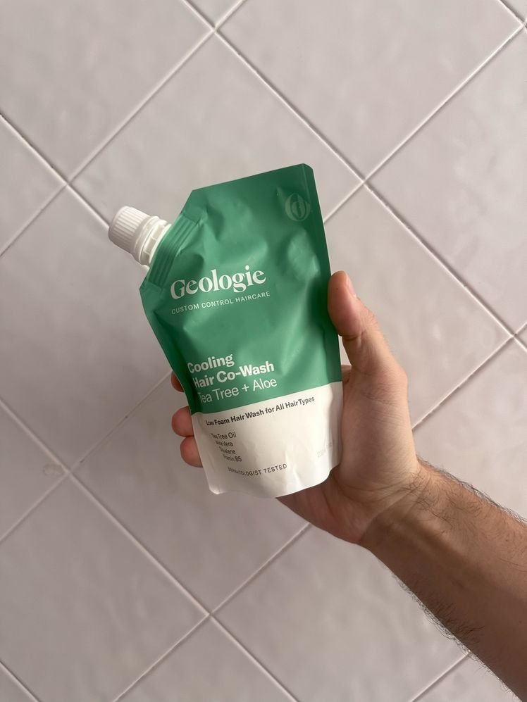 Close up of a holding Cooling Hair Co-Wash from Geologie