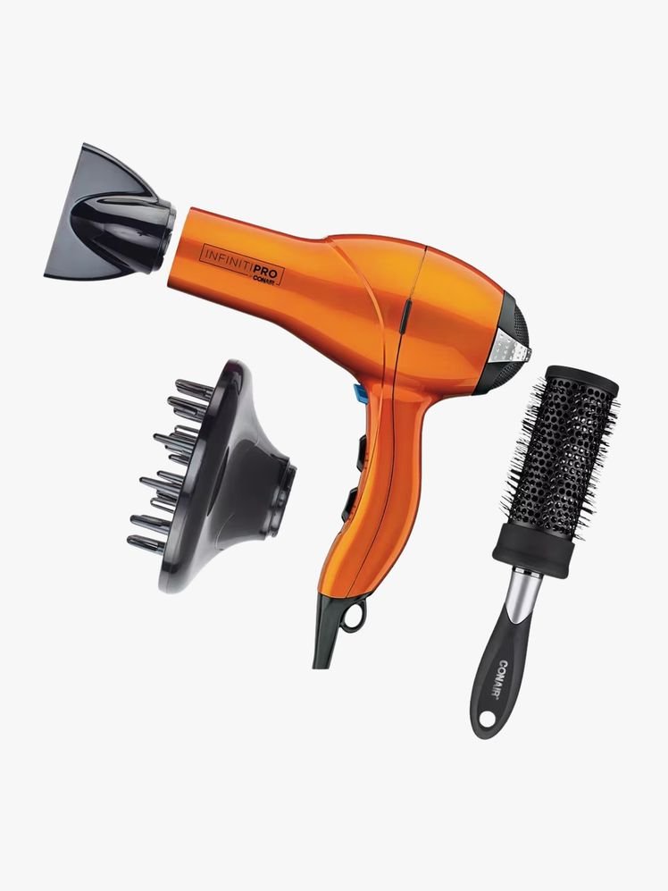 Hair dryer and parts on a flat background.